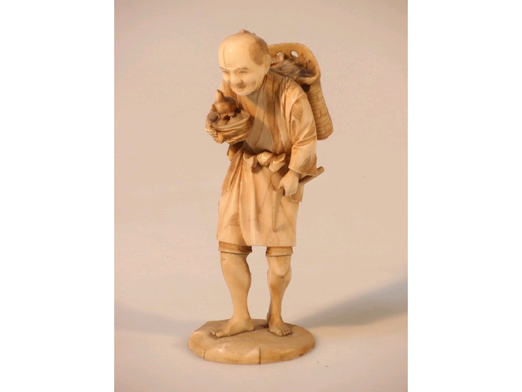 Appraisal: A Japanese carved ivory figure on a mount holding a