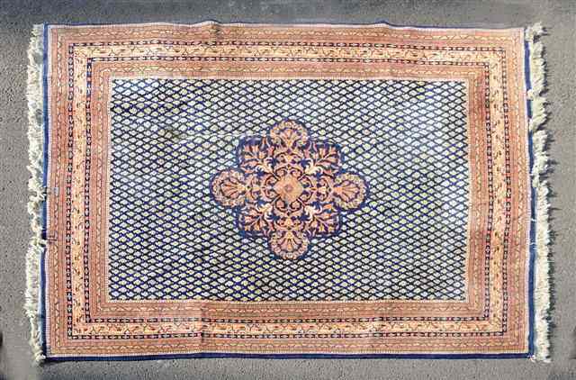 Appraisal: A PERSIAN SERRABEND DESIGN BLUE GROUND SMALL CARPET decorated a