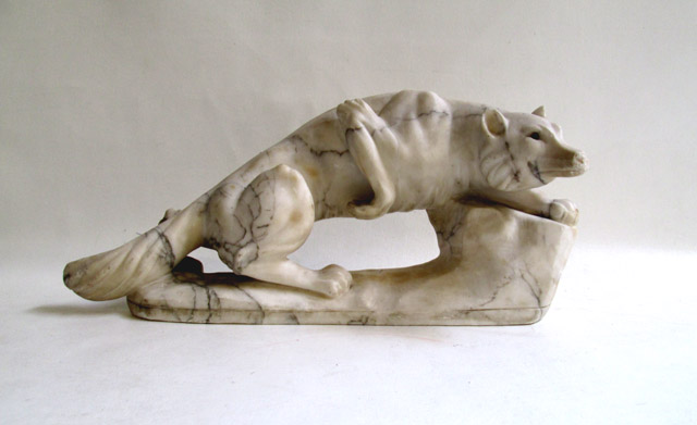 Appraisal: ALABASTER WILDLIFE SCULPTURE depicting a wolf crouching in a hunting