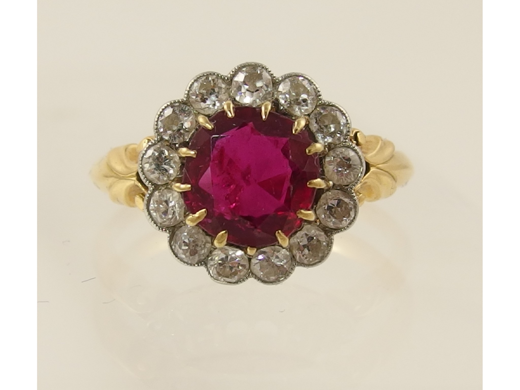 Appraisal: A yellow metal diamond and red gem set ring Diamonds