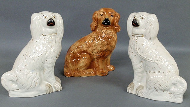 Appraisal: Pair of th c Staffordshire white seated Spaniels h and