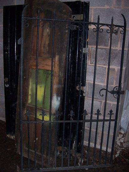 Appraisal: A pair of arched wooden garden gates with planked panels