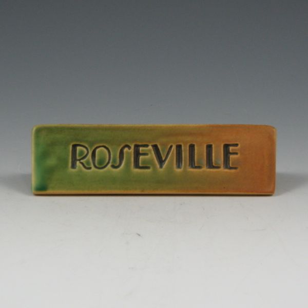 Appraisal: Double-sided Roseville Rainbow dealer sign in green and brown Mint