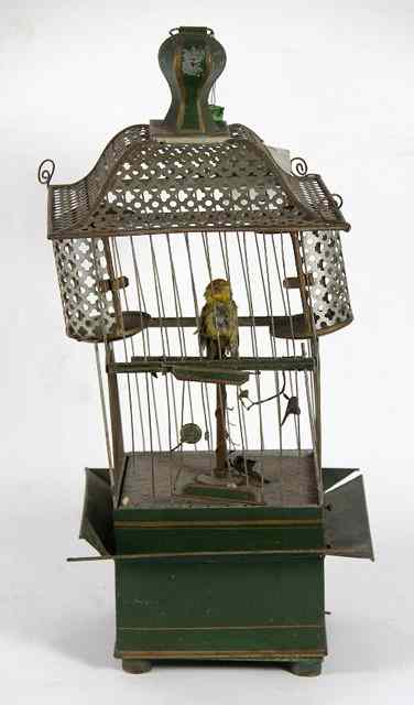 Appraisal: A singing bird automaton in a green and gilt painted