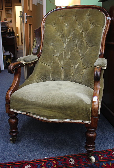 Appraisal: A VICTORIAN MAHOGANY BUTTON UPHOLSTERED OPEN ARMCHAIR with serpentine fronted