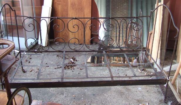 Appraisal: A French black painted wrought iron cot cm wide