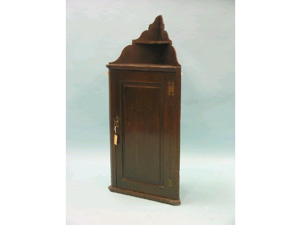 Appraisal: An th century oak hanging corner cupboard two shelves enclosed