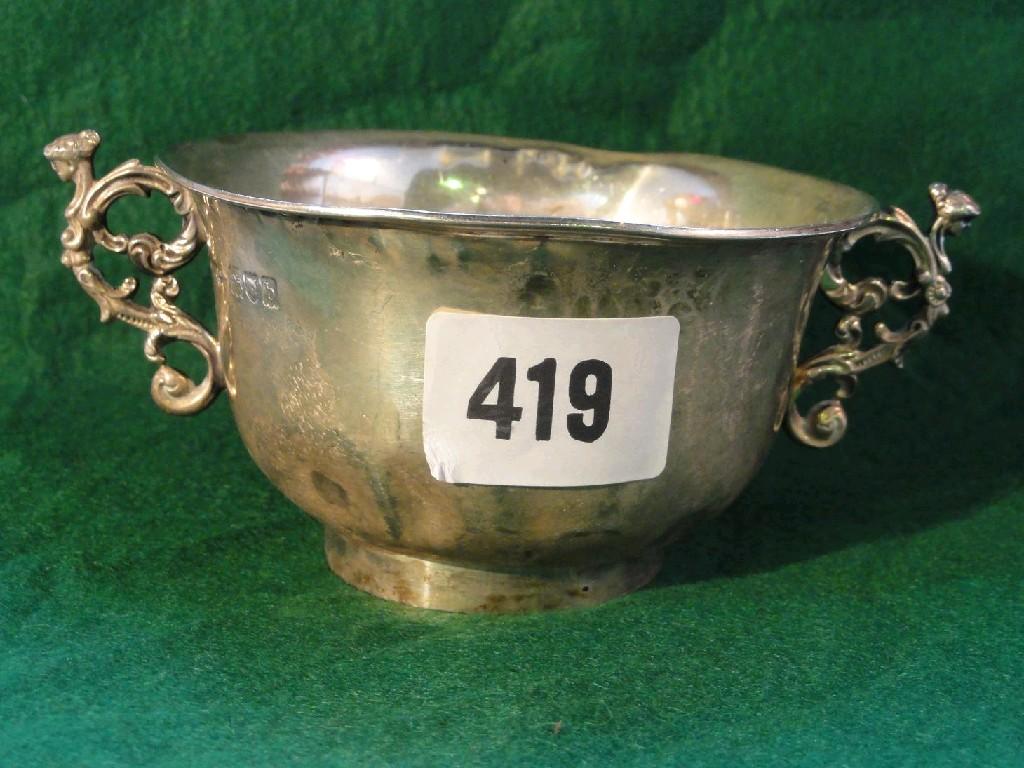 Appraisal: An open silver bowl on pedestal foot with shaped handles