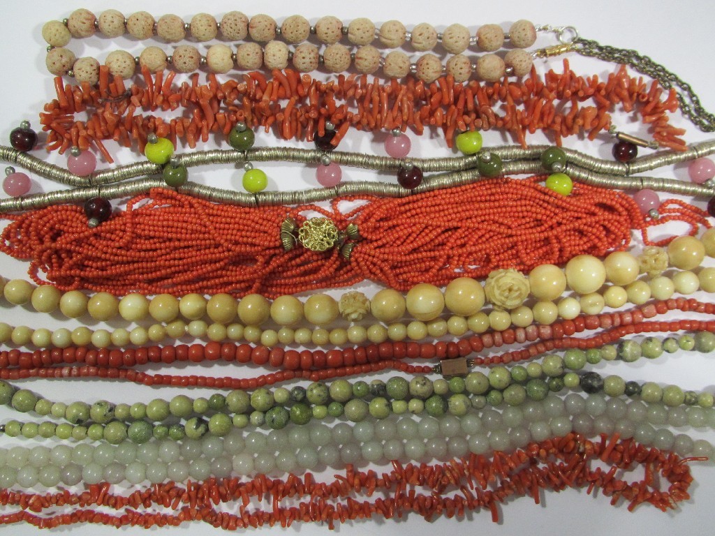 Appraisal: Nine strings of beads to include coral jade ivory Connemara