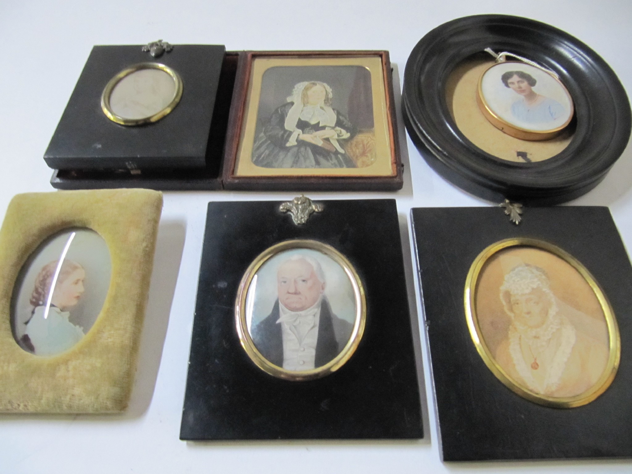 Appraisal: A lot comprising six assorted portrait miniatures and a frame