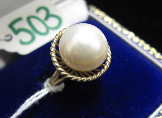 Appraisal: PEARL AND FOURTEEN KARAT WHITE GOLD SOLITAIRE RING set with