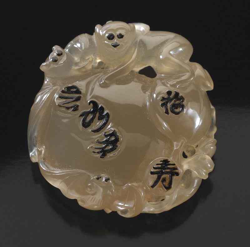 Appraisal: Chinese Qing carved Su Zhou agate toggledepicting two monkeys and