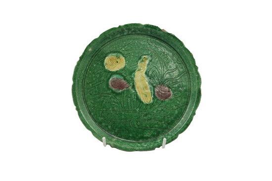 Appraisal: A Ming green glazed dish with serrated border and incised