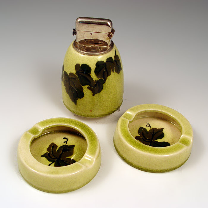 Appraisal: ROOKWOOD POTTERY PIECE SMOKE SET Lighter and ashtrays Decorated by