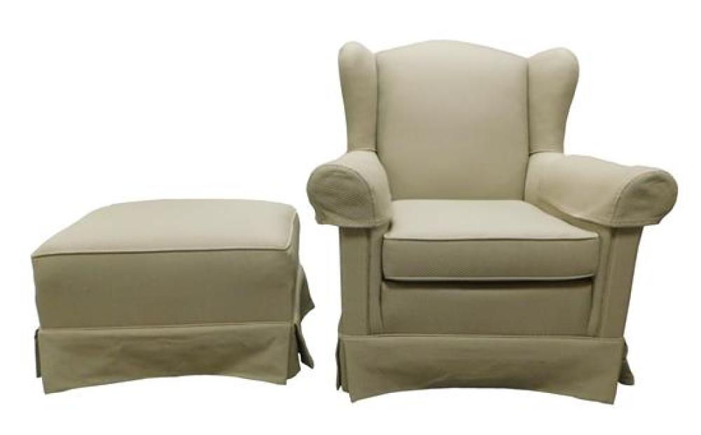 Appraisal: Wing chair and companion stool with tan fabric roll arms