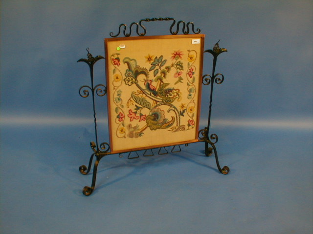 Appraisal: A late Victorian wrought iron and needlework firescreen