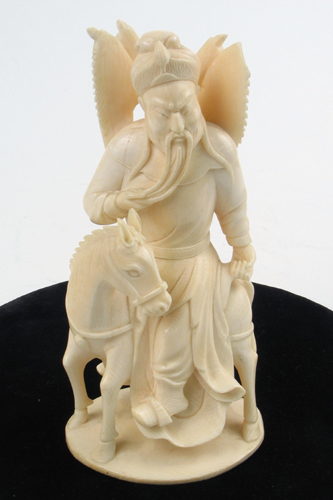 Appraisal: AN IVORY CARVED FIGURE depicting a Chinese man astride a