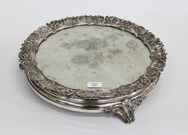 Appraisal: A CIRCULAR SILVER PLATED MIRRORED CAKE STAND with scrolling acanthus