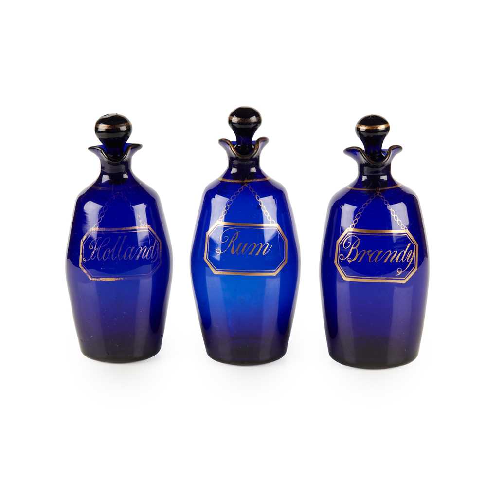 Appraisal: A SET OF THREE BRISTOL BLUE GLASS DECANTERS AND STOPPERS