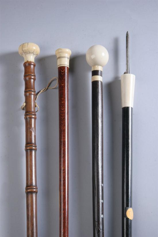 Appraisal: FOUR IVORY HANDLED CANES One with a small ivory screw-top