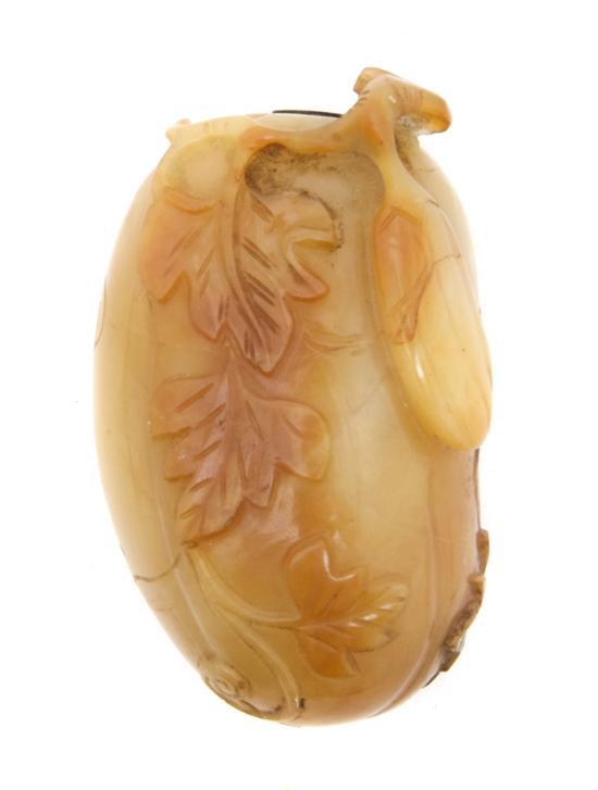 Appraisal: A Melon Form Hardstone Snuff Bottle with sinuous vines and