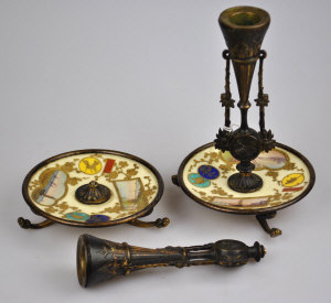 Appraisal: A pair of continental gilt metal candlesticks raised on pictorial