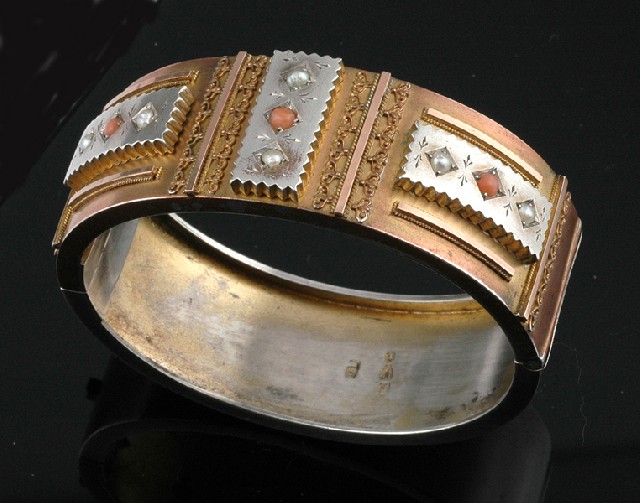 Appraisal: A VICTORIAN PEARL CORAL AND GILT BANGLE Circa Modelled in