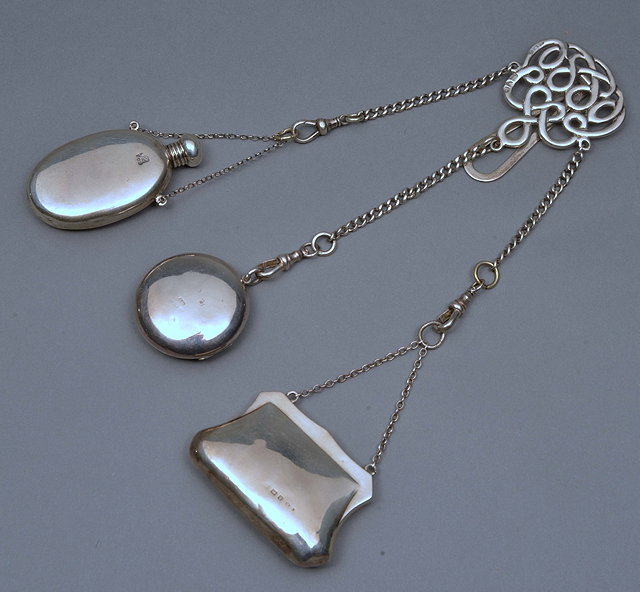 Appraisal: A PLAIN SILVER CHATELAINE of open scroll form by Saunders