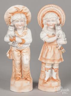 Appraisal: Pair of bisque figures of a boy and girl holding