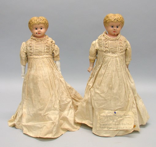 Appraisal: Pair of blonde metal shoulderhead dolls Sisters with same head