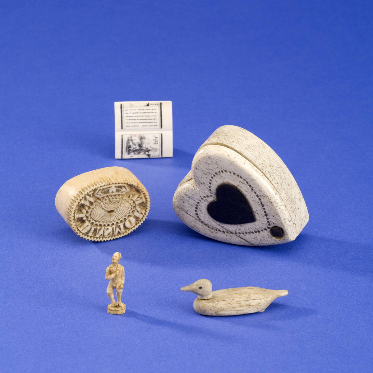 Appraisal: GROUP OF FIVE SCRIMSHAW AND WHALEBONE OBJECTS INCLUDING A HEART