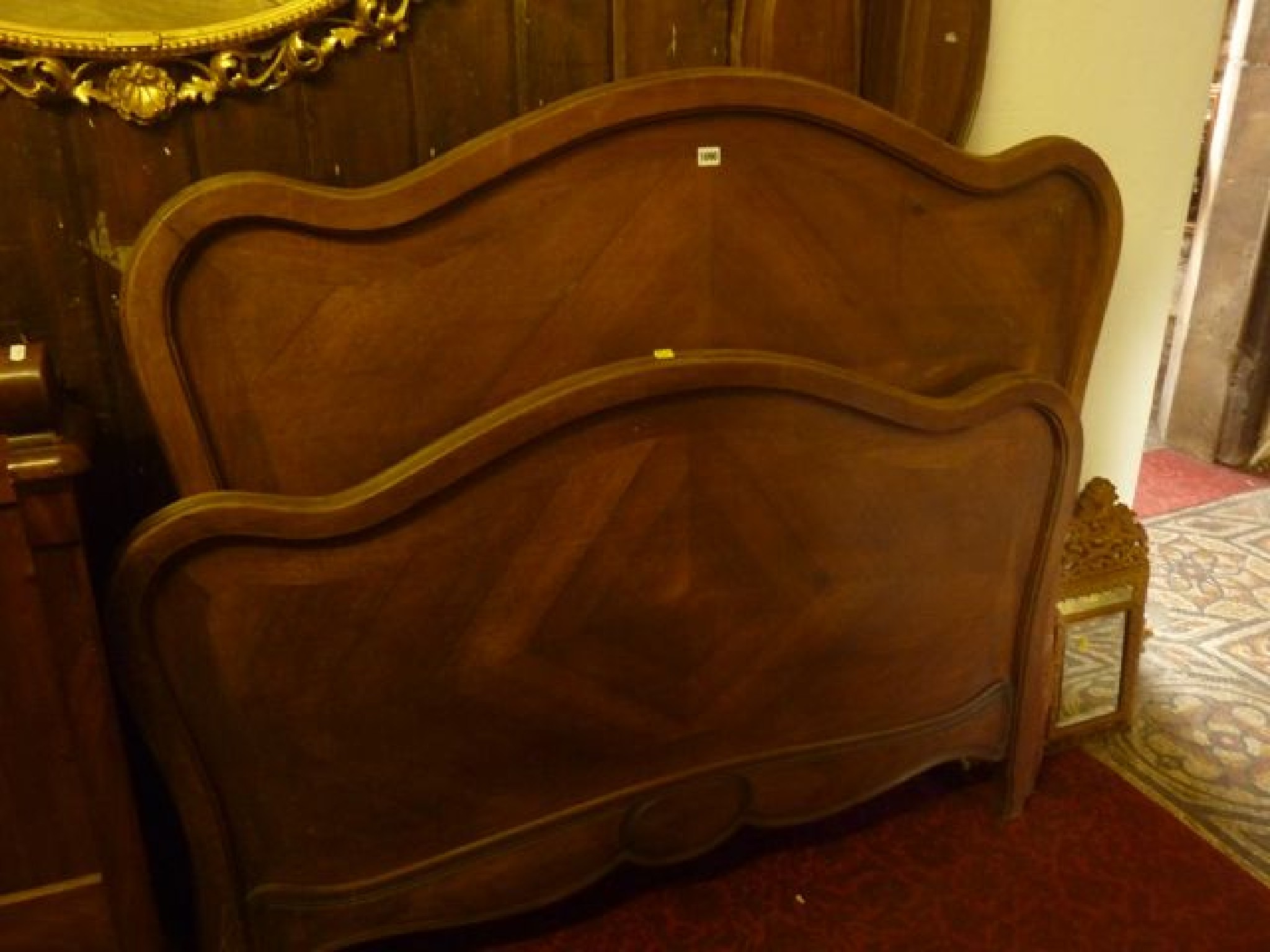 Appraisal: A French walnut double bedstead with shaped and moulded outline