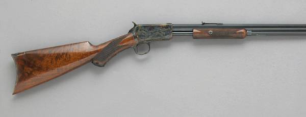 Appraisal: A Winchester Model slide action rifle with deluxe engraving and