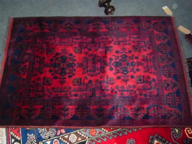 Appraisal: A TURKISH RED GROUND RUG with central foliate geometrical designs