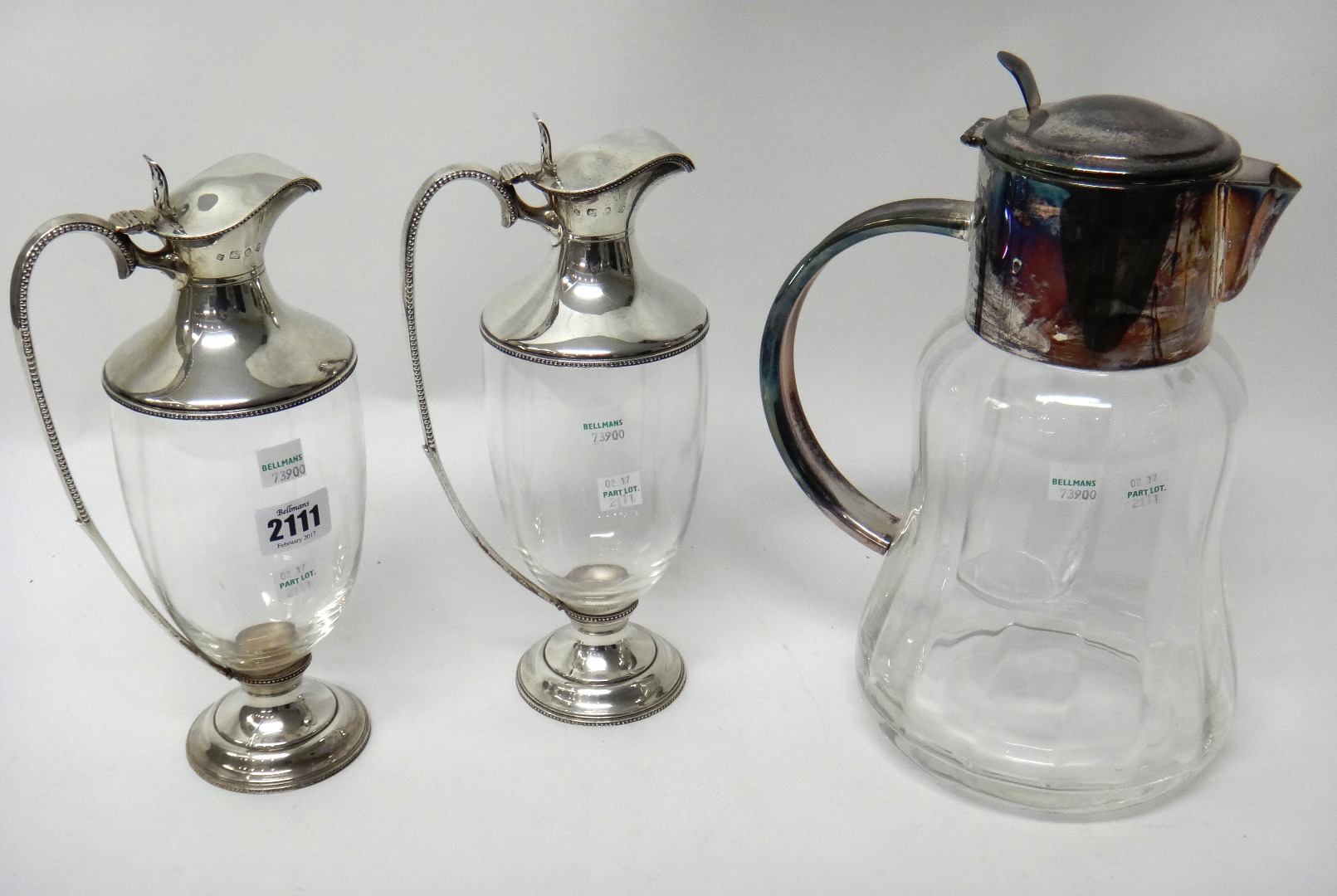 Appraisal: A pair of silver mounted glass claret jugs each or