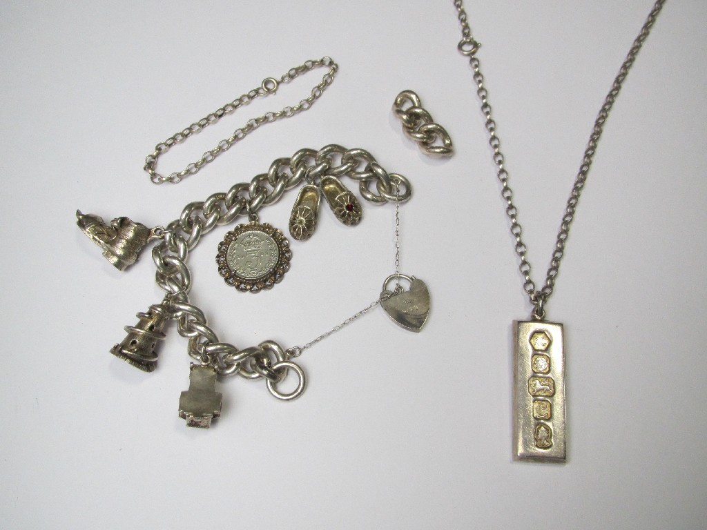 Appraisal: Silver charm bracelet and a silver ingot