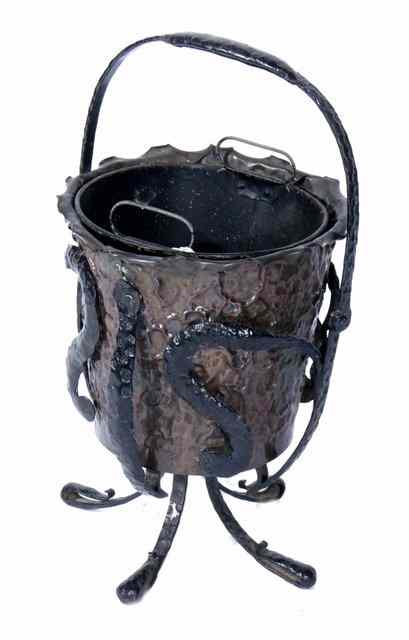 Appraisal: A STYLISED HAMMERED COPPER COAL BUCKET on wrought iron stand