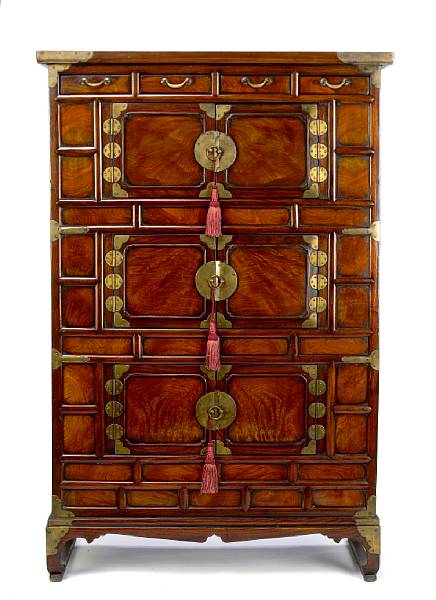 Appraisal: A Korean brass mounted elm cabinet fitted with an arrangement