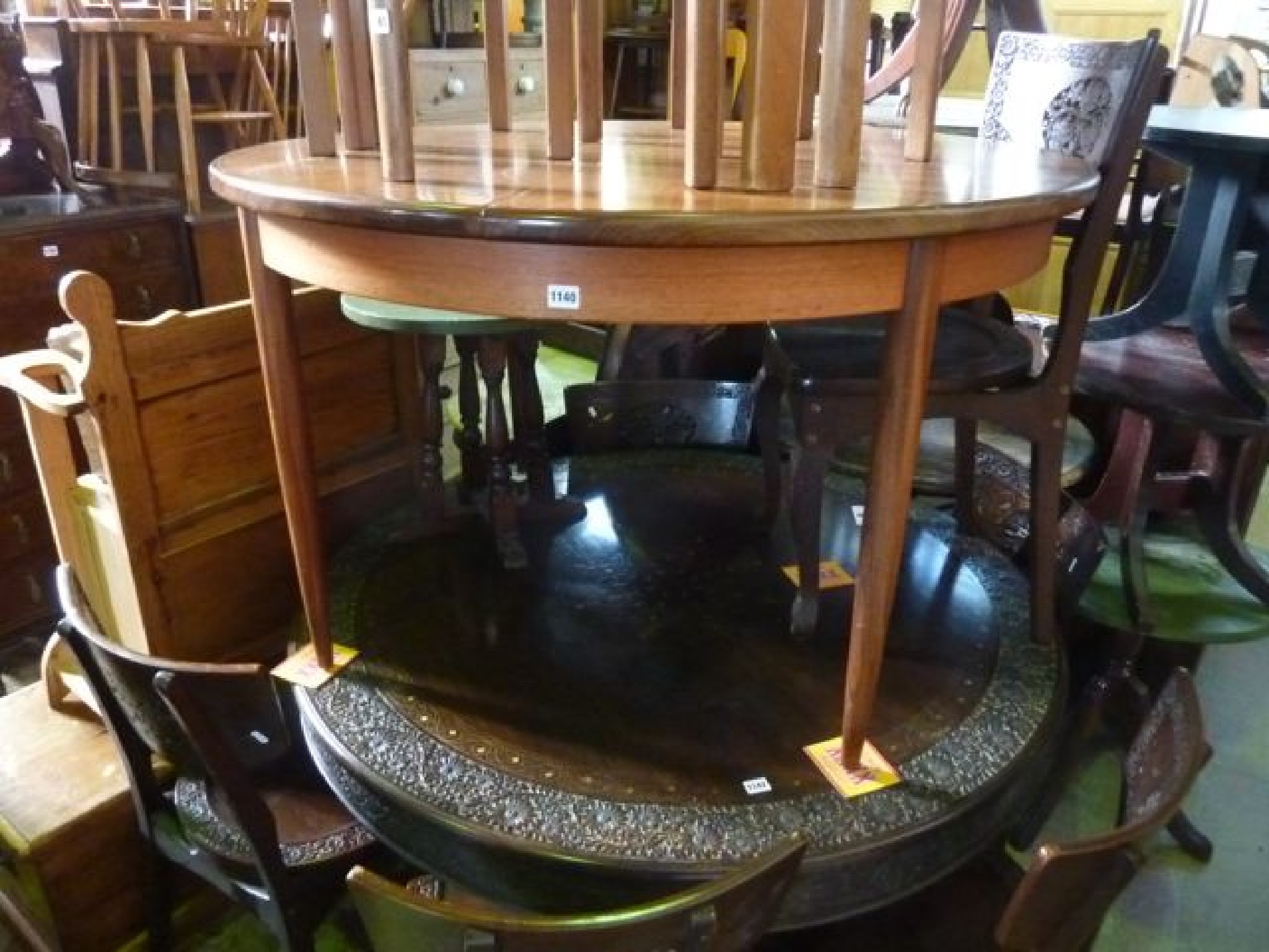 Appraisal: A teak dining table of circular form when closed with