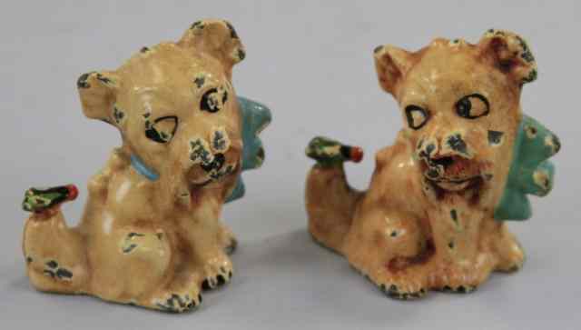 Appraisal: DOGS WITH BUGS ON TAILS PAPERWEIGHTS Whimsical cast iron examples