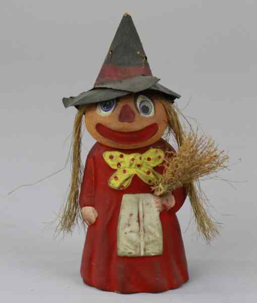 Appraisal: PUMPKIN HEAD WITCH HALLOWEEN FIGURE Early pumpkin head witch holding