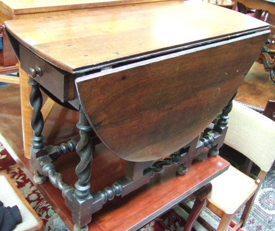 Appraisal: An th century oak drop flap table the oval top