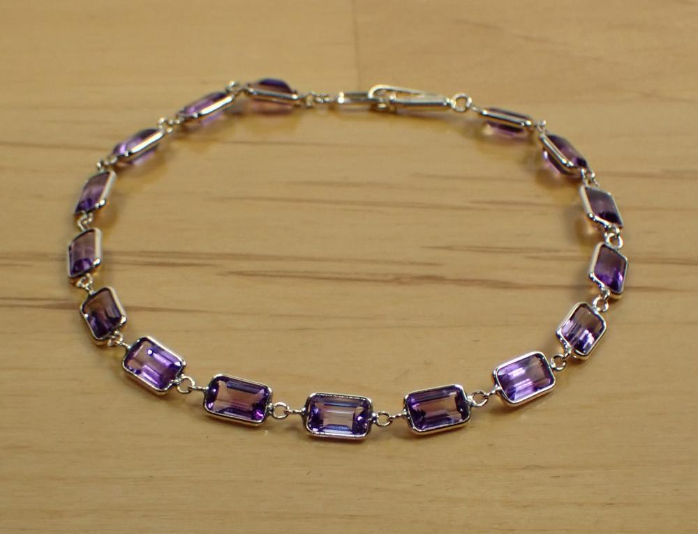 Appraisal: AMETHYST AND FOURTEEN KARAT GOLD BRACELET set with emerald-cut amethysts