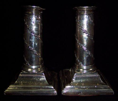 Appraisal: A pair of desk candlesticks of column form entwined bands