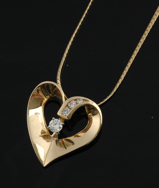 Appraisal: A diamond pendant necklace The ct gold open heart pendant