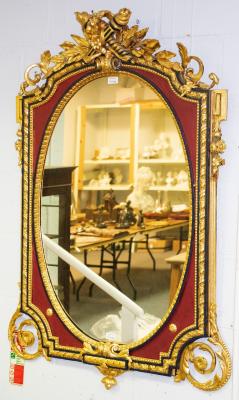 Appraisal: An Empire style gilt framed mirror with crossed torches to