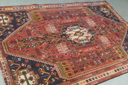 Appraisal: SEMI-ANTIQUE PERSIAN SHIRAZ CARPET central geometric medallion and overall stylized