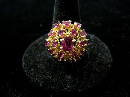 Appraisal: karat yellow gold ruby cluster ringCentral oval ruby framed by