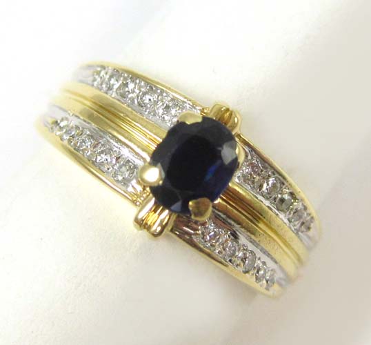 Appraisal: SAPPHIRE DIAMOND AND EIGHTEEN KARAT GOLD RING centering an oval-cut