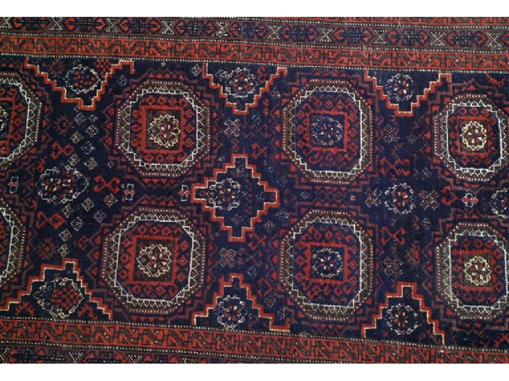 Appraisal: BALUCHI RUG with eight medallions against a blue ground within